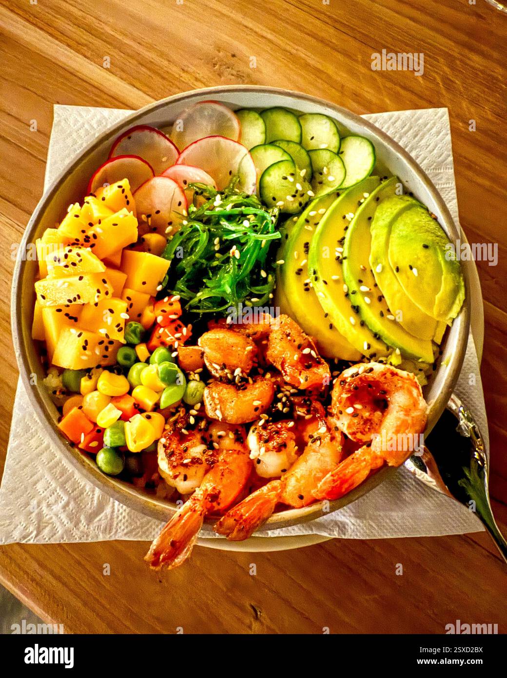 Vibrant Healthy Bowl Packed with Vitamins A colorful and nutritious healthy bowl featuring radishes, cucumber, shrimp, seaweed, avocado, and mango. - Smartphone Captured Stock Image