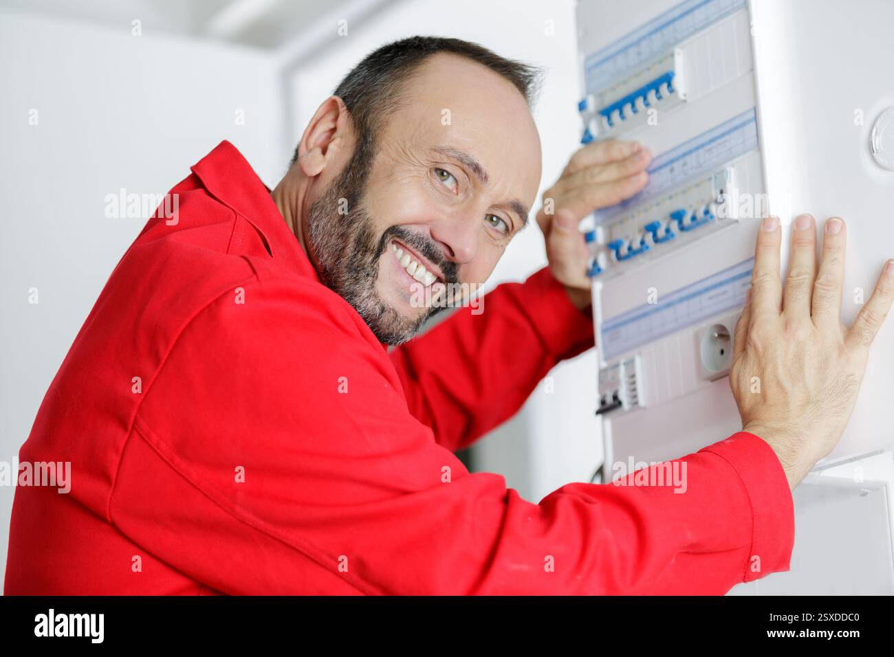 electrician installing energy saving meter Stock Photo