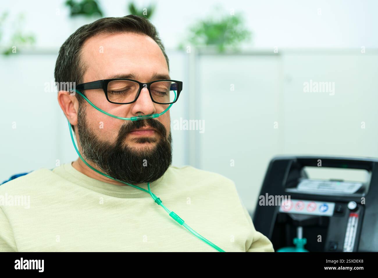 Oxygen therapy, also referred to as supplemental oxygen. Man inhaling ...