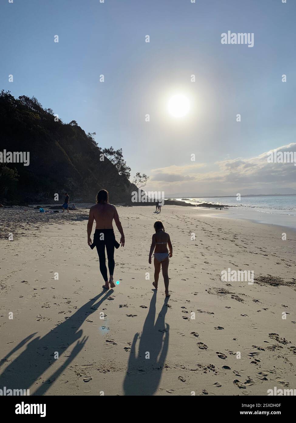 father and daughter walk on the beach - Smartphone Captured Stock Image