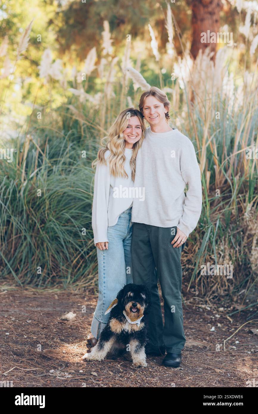 Young Couple Posing with their dog Stock Photo