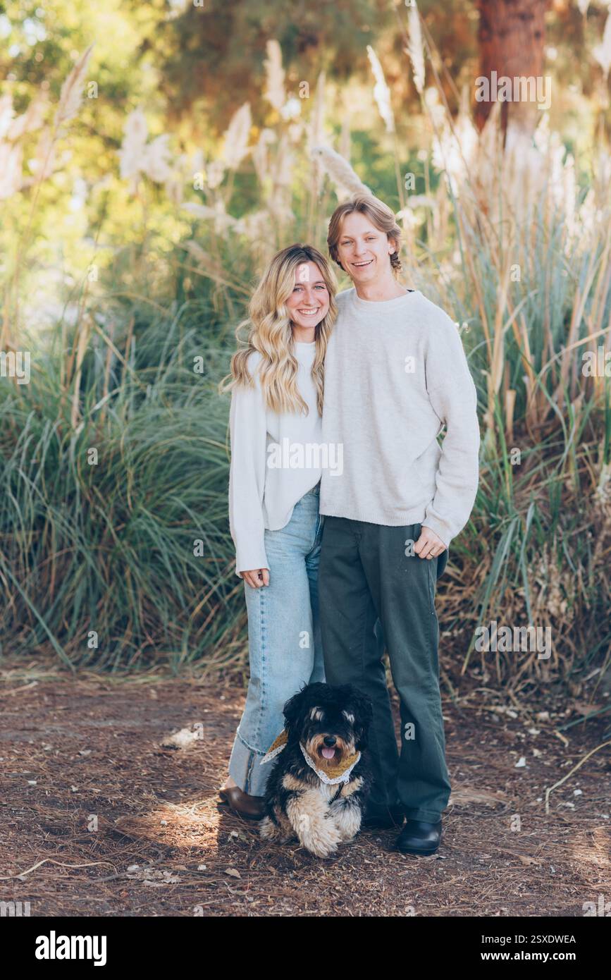 Young Couple Posing with their dog Stock Photo