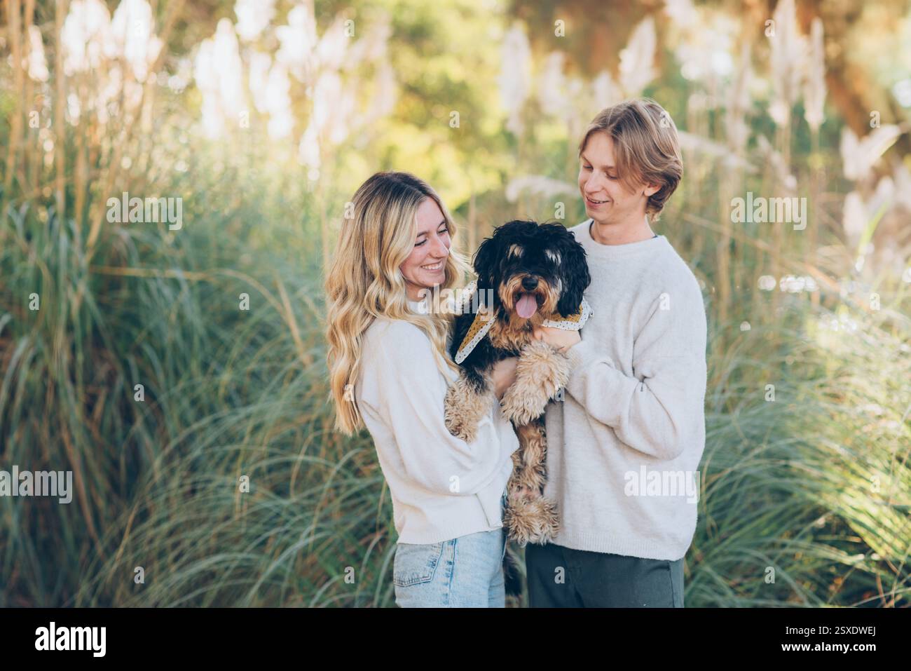 Young Couple Posing with their dog Stock Photo