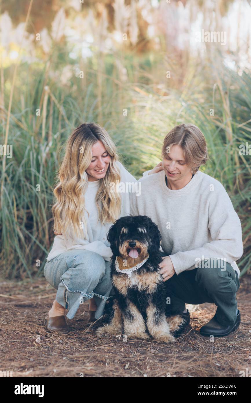 Young Couple Posing with their dog Stock Photo