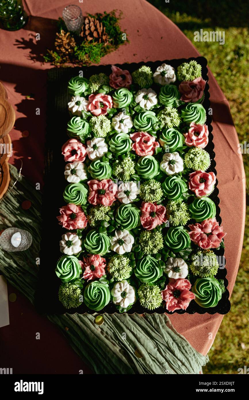 Succulent wedding cupcake display with floral decorations Stock Photo