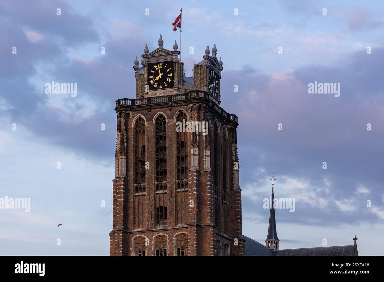A majestic Gothic church under a dramatic cloudy sky. The intricate ...