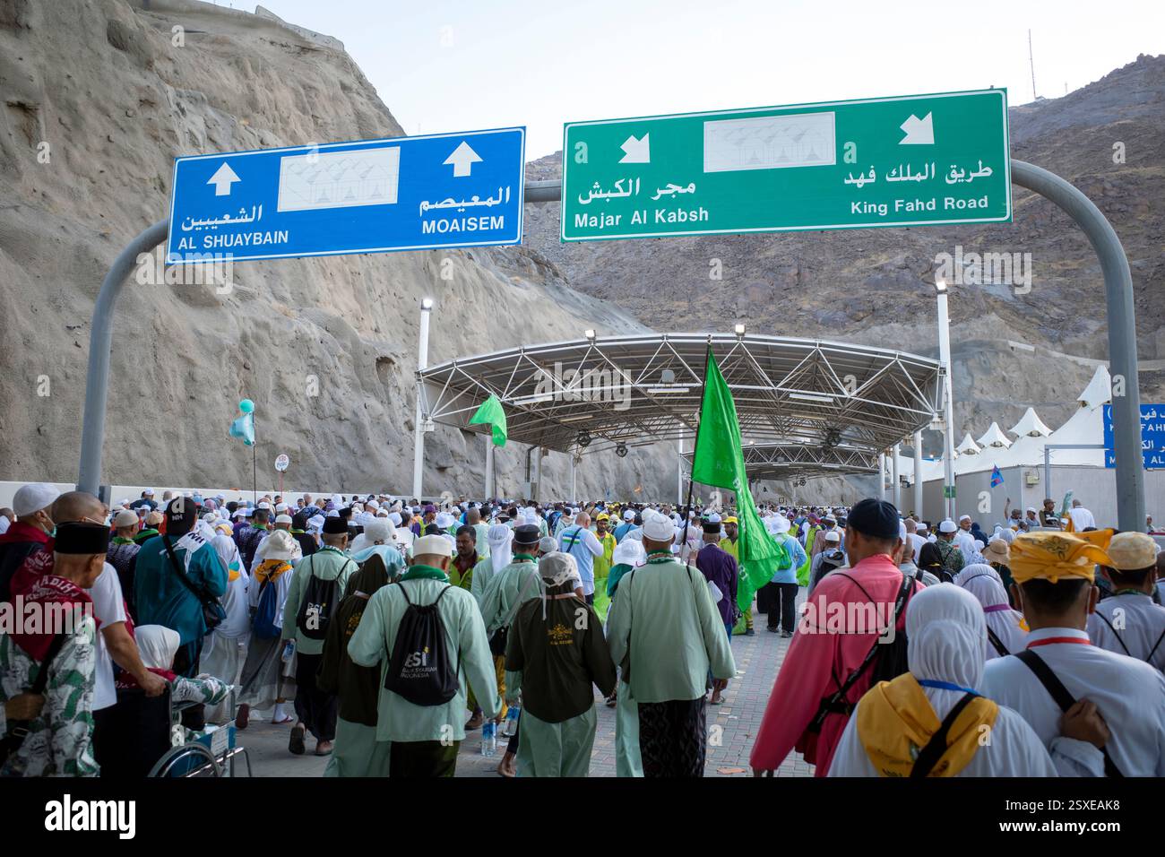 Mecca, Saudi Arabia - June 18, 2024: Pilgrims walking towards the Jamarat stoning ritual in Mina, Saudi Arabia in the Hajj season. Stock Photo