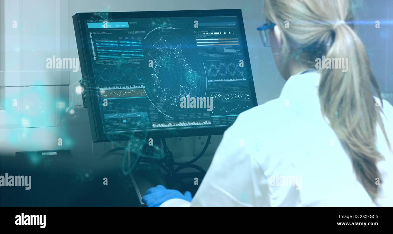 Image of data processing over caucasian female scientist using computer in laboratory Stock Photo