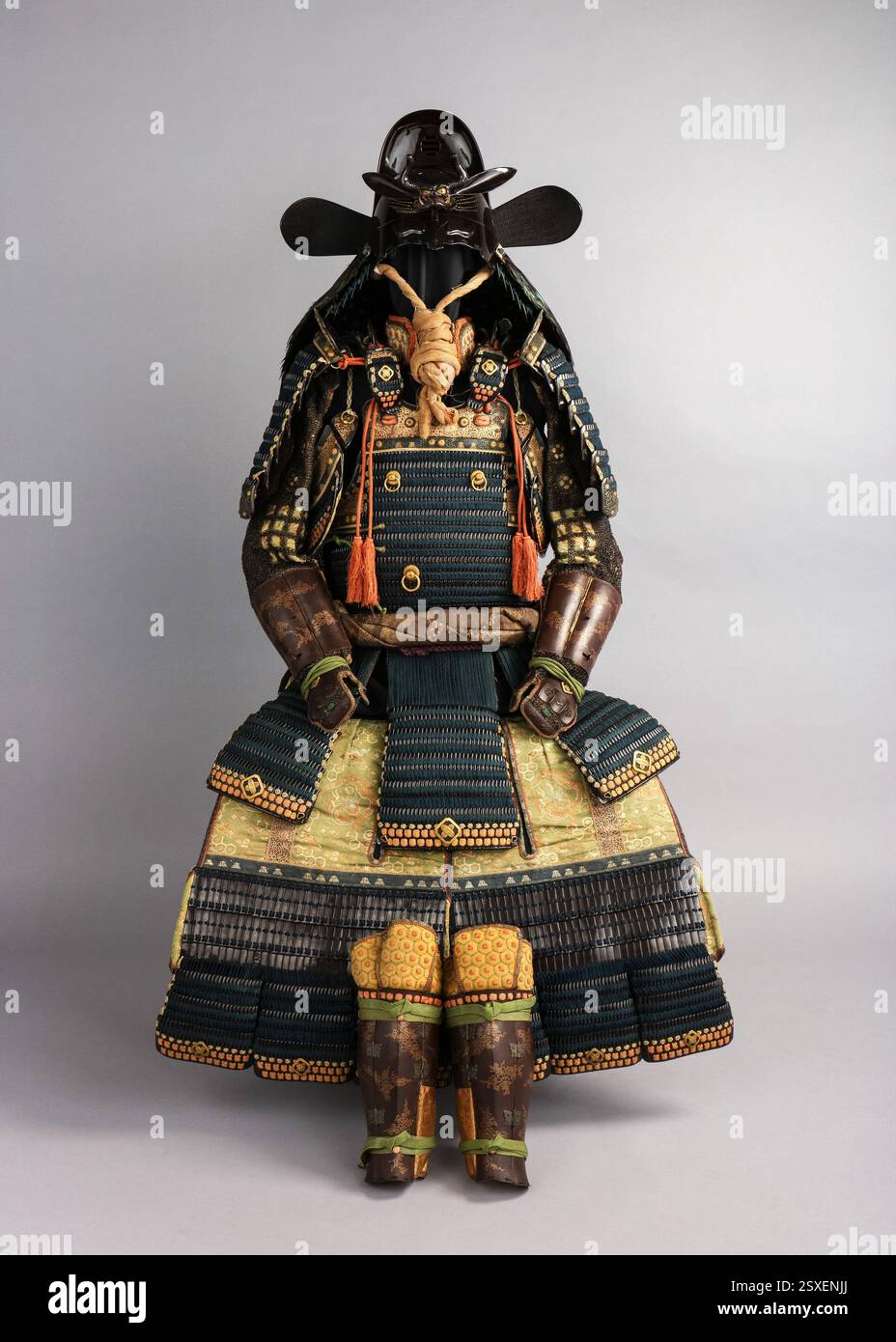 A 19th-century Gusoku armor featuring a helmet bowl from the early 18th century by Neo Masanobu. This suit reflects the late Edo period’s decorative emphasis, combining practical elements with ornamental luxury. Unique features include a medicine container and an inkstone. Stock Photo