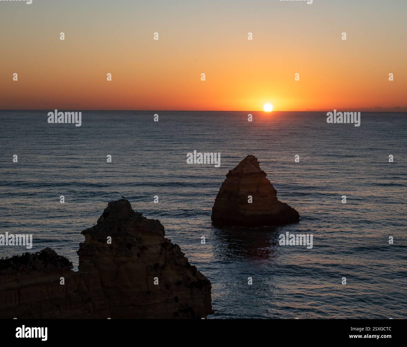 Sunrise over Praia do Camilo beach near Lagos town, Algarve province, Portugal. Stock Photo