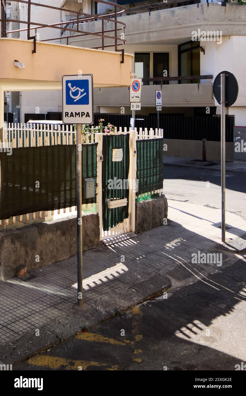 Sign Ramp Green A bright urban street in Catania, Sicily, showing a disability ramp ...