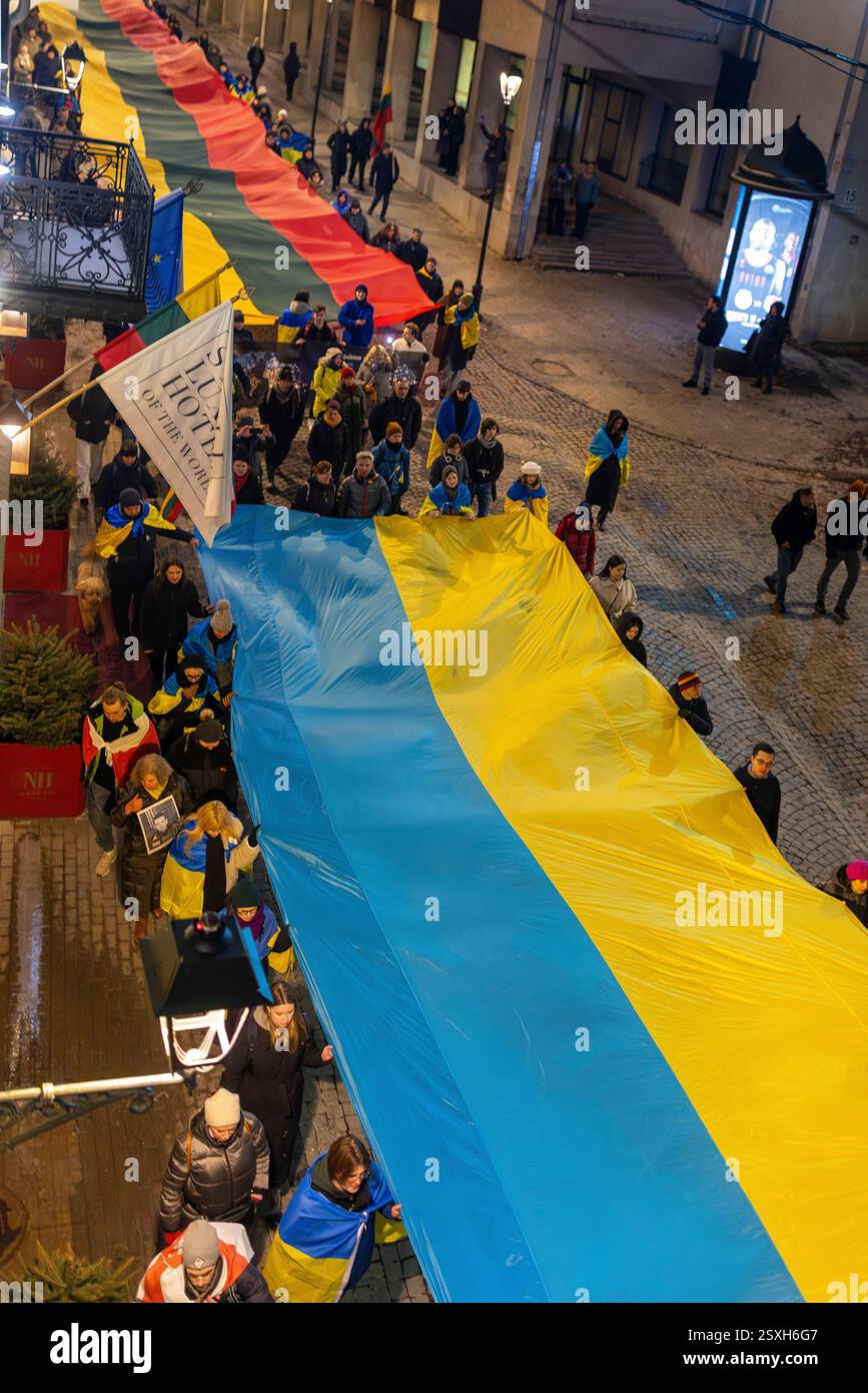 People carry giant Ukrainian and Lithuanian flags to mark the third