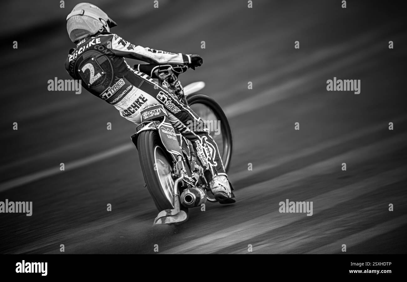 Monochrome Motion Photo Of Australian Speedway Rider Tate Zishcke Powering Out Of A Bend At Glasgow Speedway Whilst Riding For Workington Comets Team Stock Photo