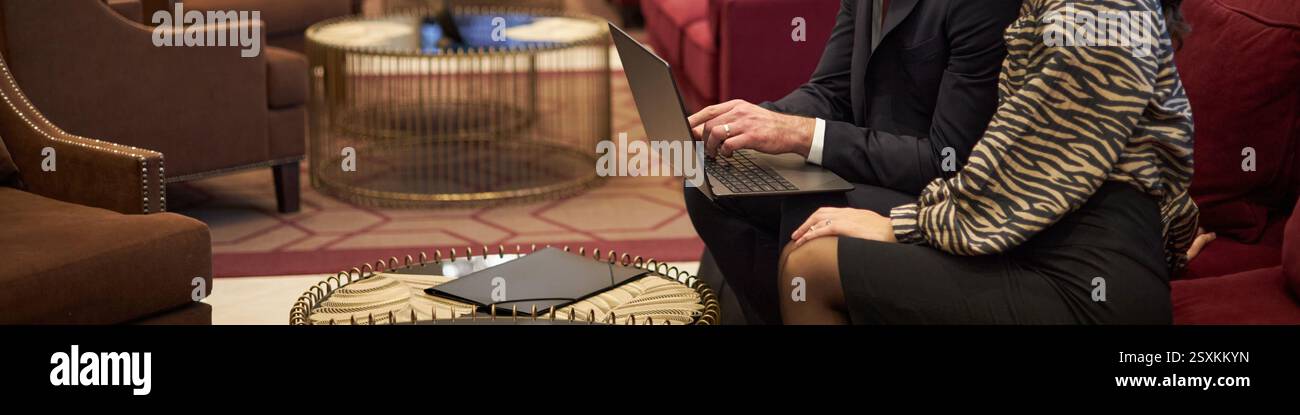 Collaborating on Report in Modern Lounge Setting Stock Photo