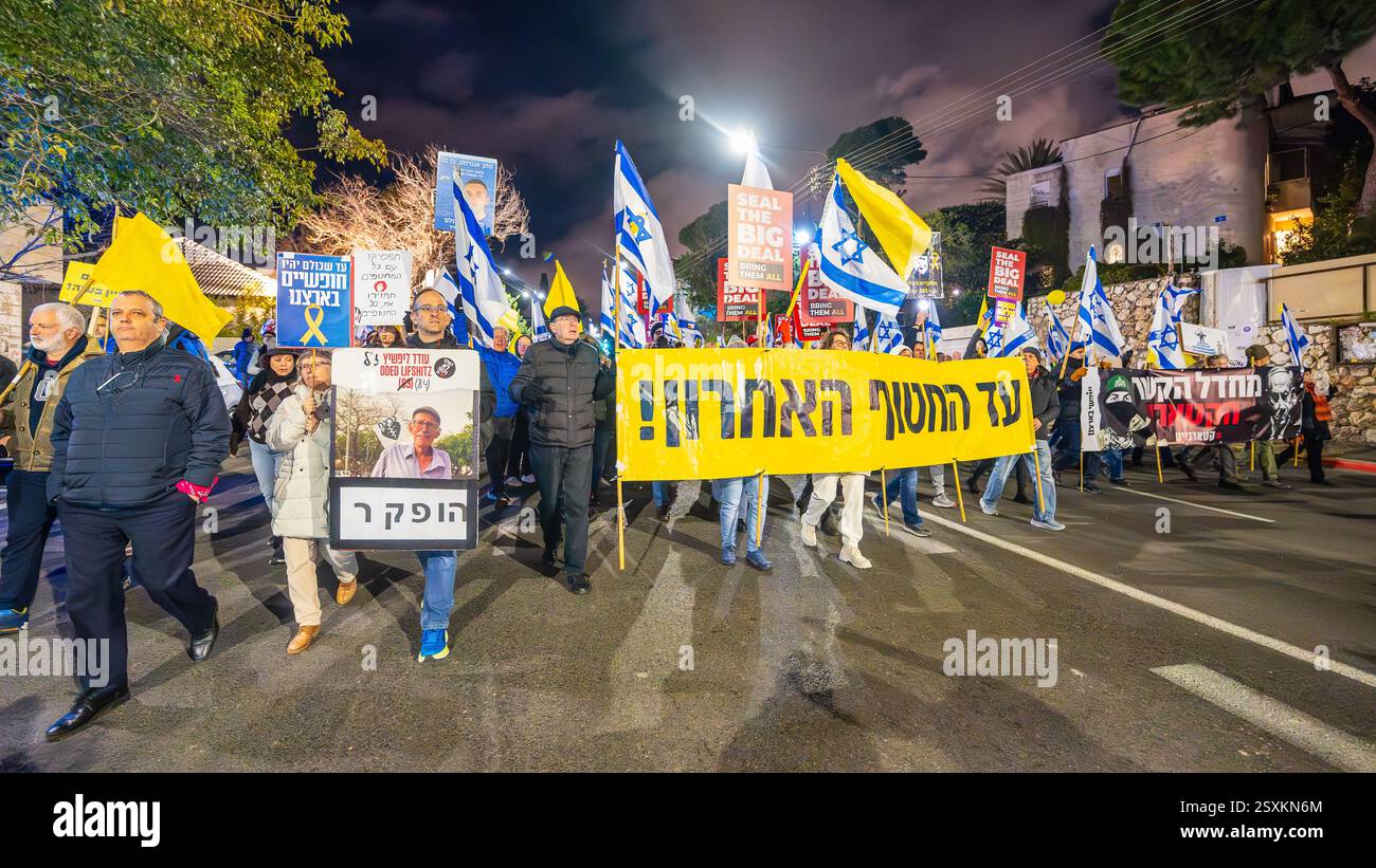 Haifa, Israel - February 22, 2025: People with various signs and flags ...