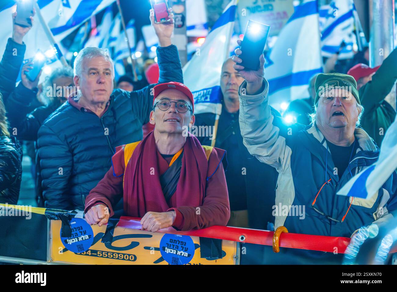 Haifa, Israel - February 22, 2025: Crowd of people with various signs ...