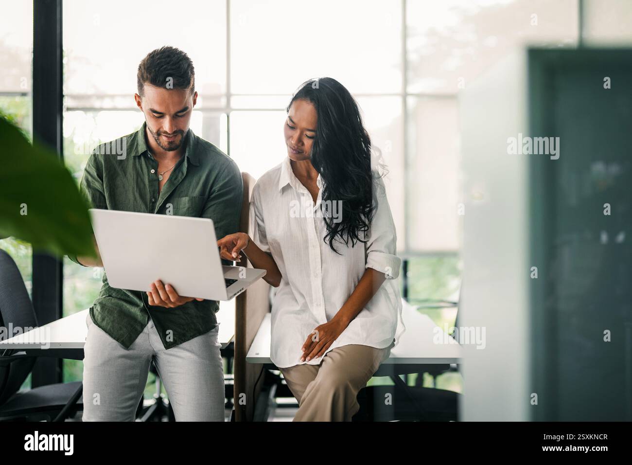 Mixed team of software engineers brainstorming ideas. Diverse app developers collaborating as group Stock Photo