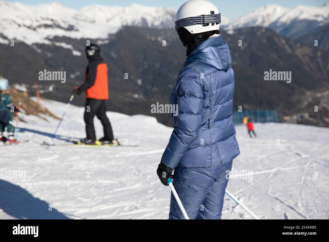 Skiers and snowboarders ride on a mountain ski track Stock Photo - Alamy