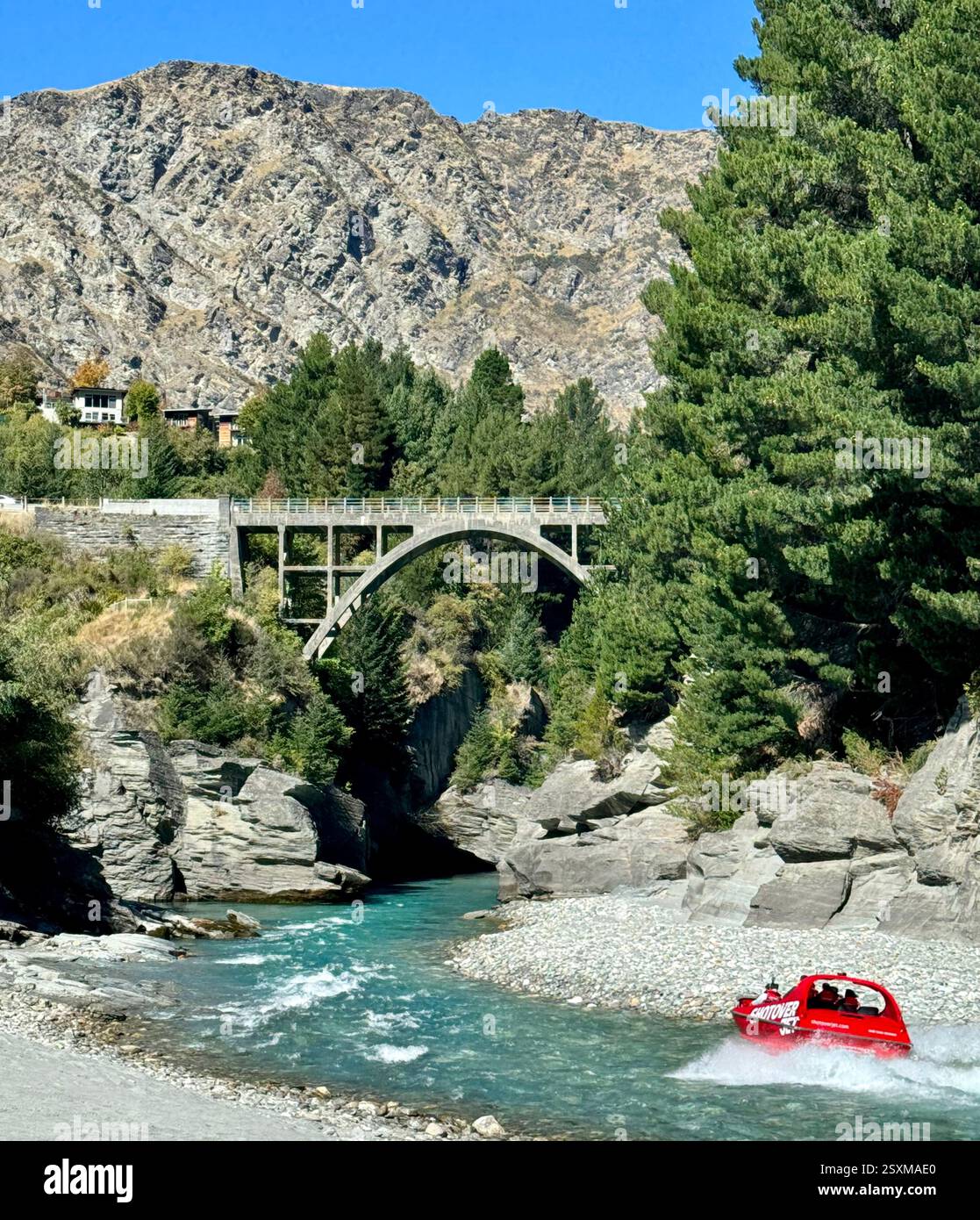 Shotover Jet boat ride on the Shotover River with Edith Cavell Bridge Queenstown South Island New Zealand - Smartphone Captured Stock Image