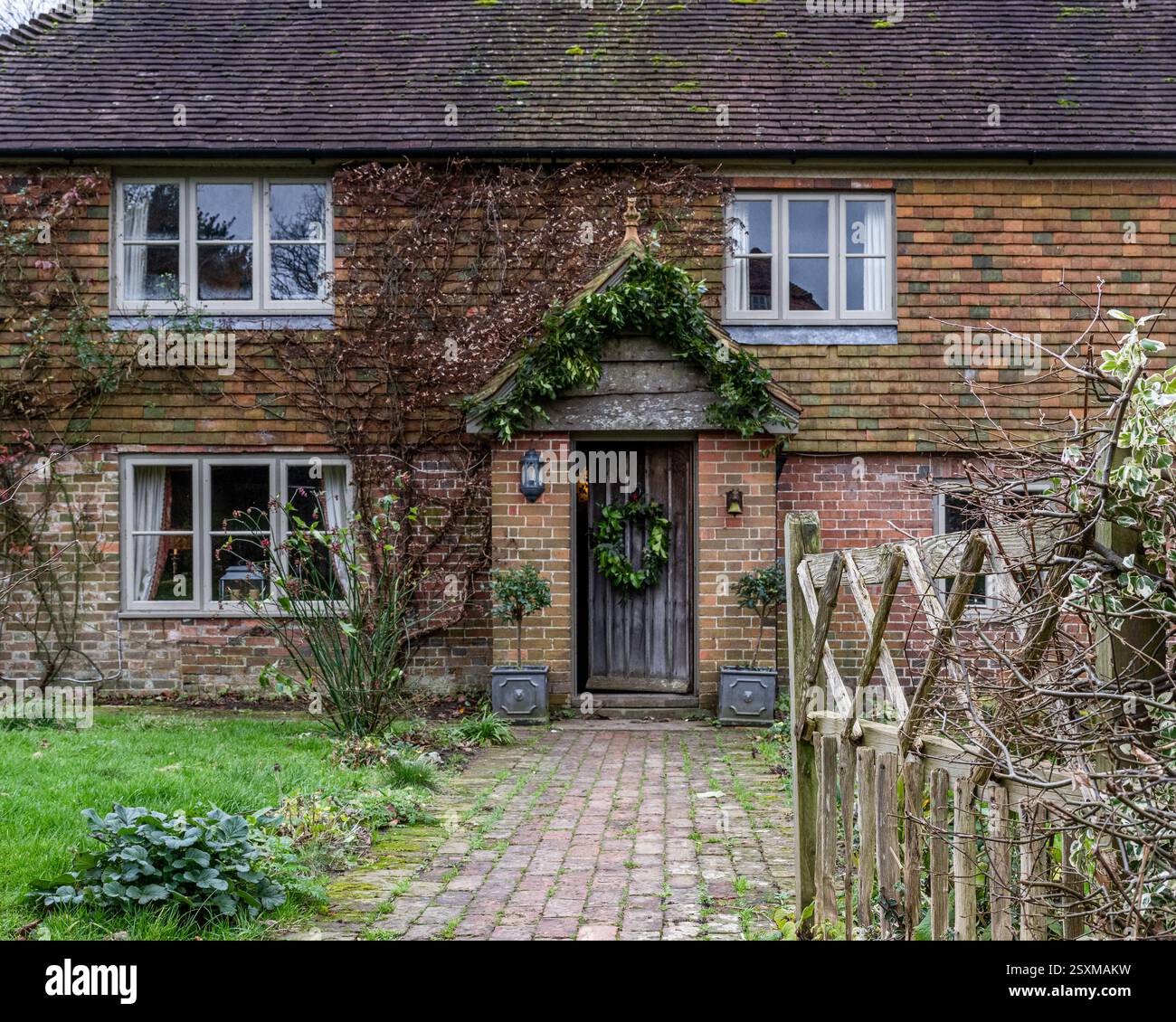 Christmas wreath on front door of East Sussex Tudor farmhouse dating from 1540, England, UK. Stock Photo