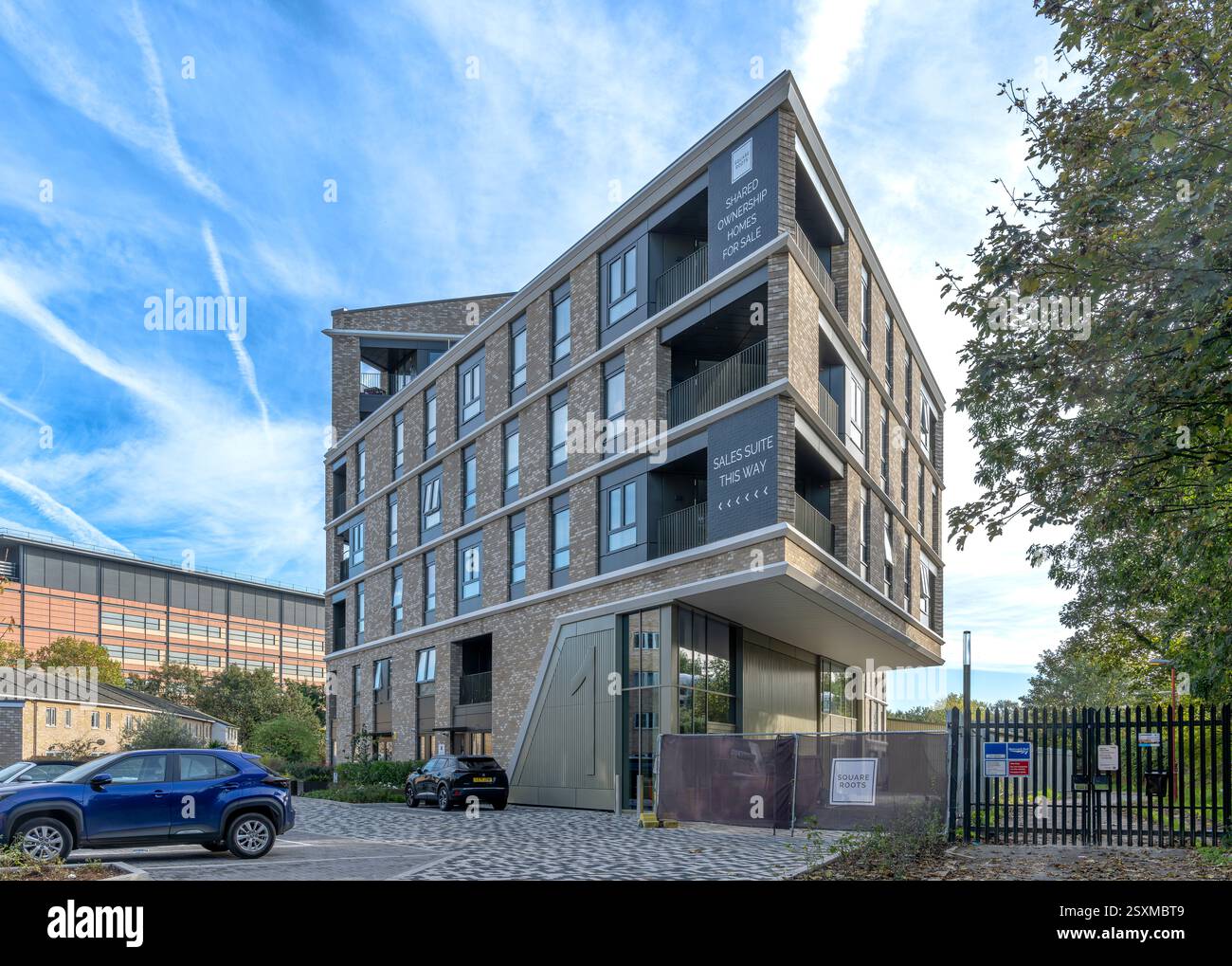 Dramatic new triangular apartment block in a corner plot between the railway and Ravensbourne River. With shared ownership homes for sale. Stock Photo