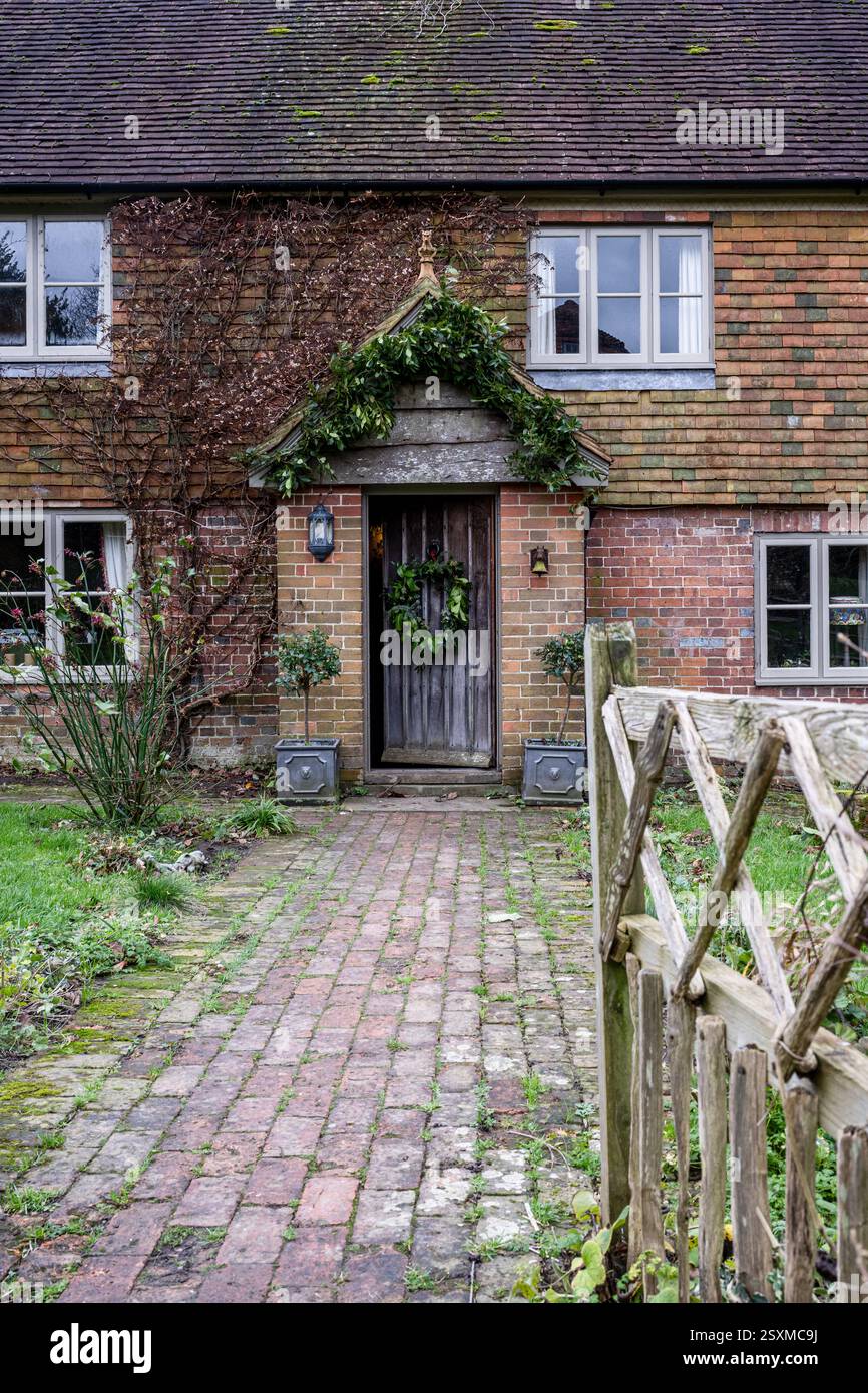 Christmas wreath on front door of East Sussex Tudor farmhouse dating from 1540, England, UK. Stock Photo