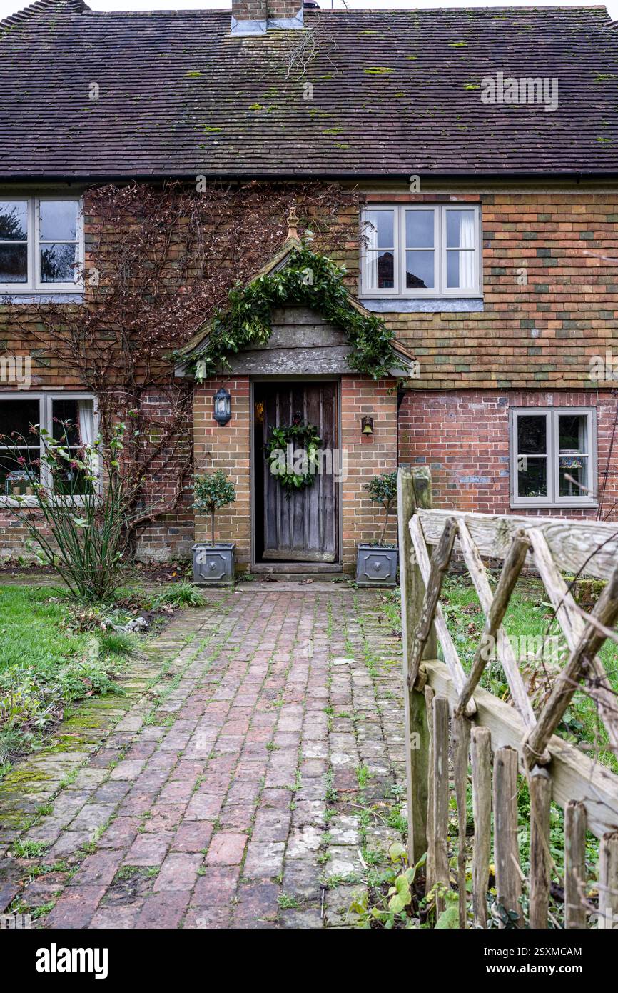 Christmas wreath on front door of East Sussex Tudor farmhouse dating from 1540, England, UK. Stock Photo