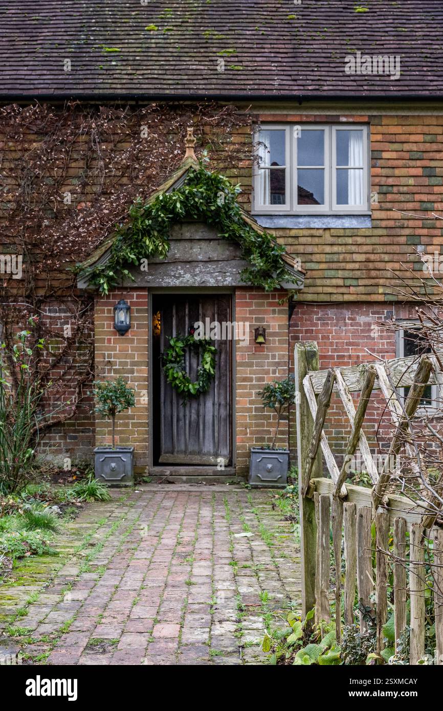 Christmas wreath on front door of East Sussex Tudor farmhouse dating from 1540, England, UK. Stock Photo