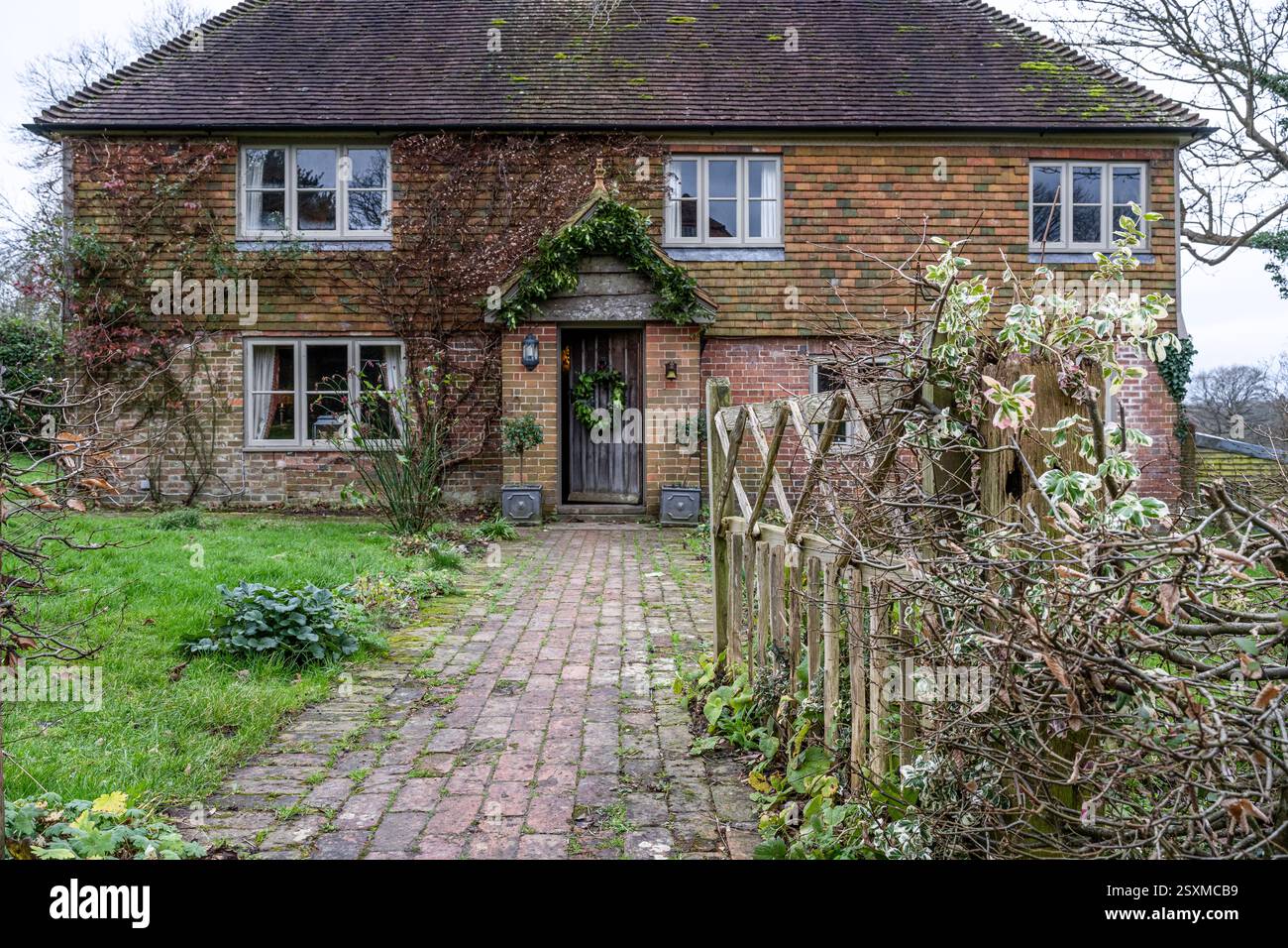 Christmas wreath on front door of East Sussex Tudor farmhouse dating from 1540, England, UK. Stock Photo