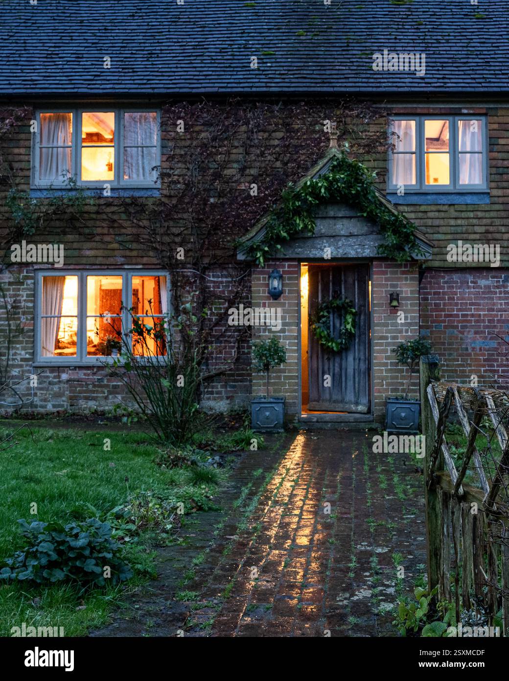 Christmas wreath on front door of traditional East Sussex Tudor farmhouse dating from 1540, England, UK. Stock Photo