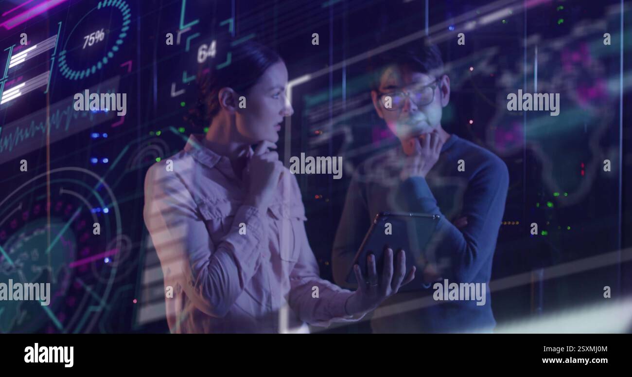 Image of data processing over diverse colleagues using tablet in server room Stock Photo