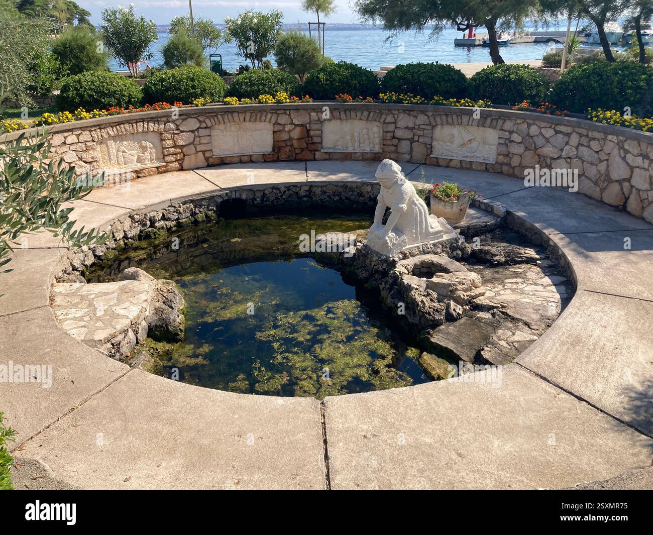 Monument to The Washer Women on Ugljan Island near Zadar, Croatia. Remembering the dead in stone. Famous tourist attraction. - Smartphone Captured Stock Image