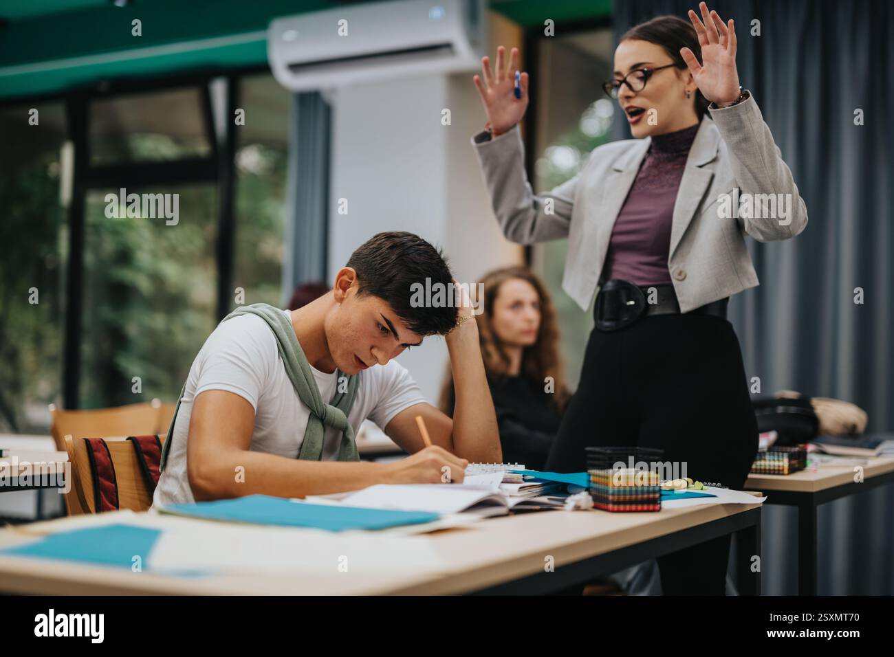 Teacher guiding students during an interactive classroom session Stock Photo