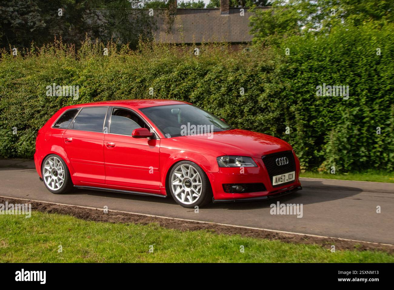 2012 Classic Red Audi A3 Sport Tdi 105 hatchback Start/Stop  1.6TD Diesel 1598 cc, being driven in the historic grounds of Worden Park, Leyland, UK Stock Photo