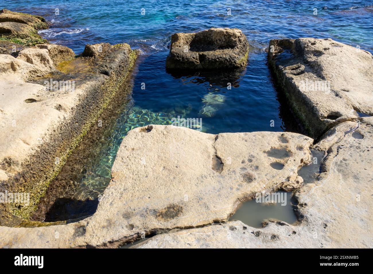 Area showing a Font Ghadir Bath, an excavated Victorian bathing pool that would have had a wooden shelter and canvas roof. Sliema, Malta. Stock Photo