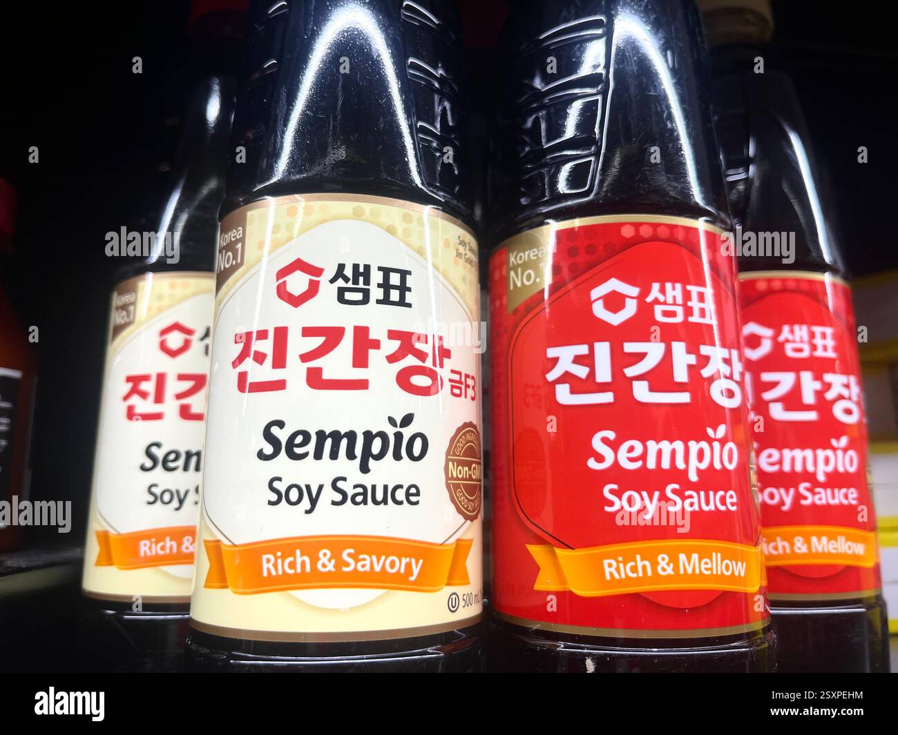 Selection of Sempio soy sauce bottles on grocery store shelf – popular Korean condiment for authentic Asian cooking and seasoning, Asian food section - Smartphone Captured Stock Image