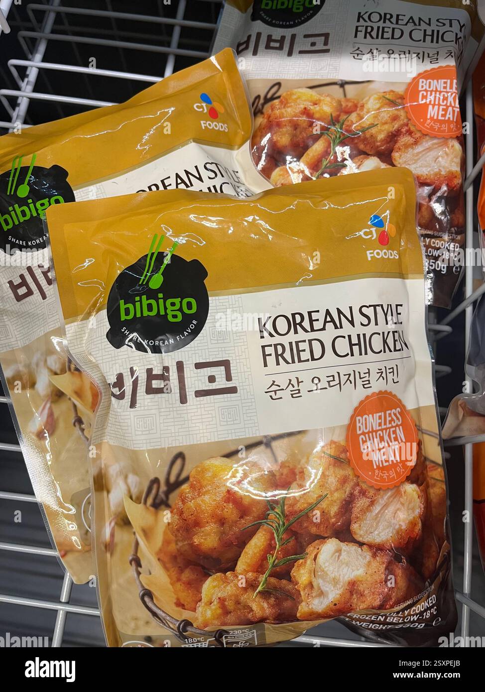 Frozen Bibigo Korean Fried Chicken on display in supermarket freezer – convenient and flavorful Korean cuisine, Asian food, Korean snacks - Smartphone Captured Stock Image