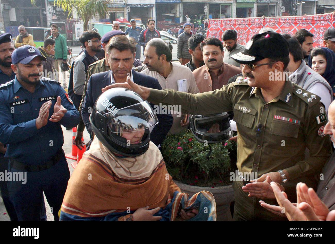 Chief Traffic Officer (CTO), Dr. Athar Waheed distributes helmets among ...