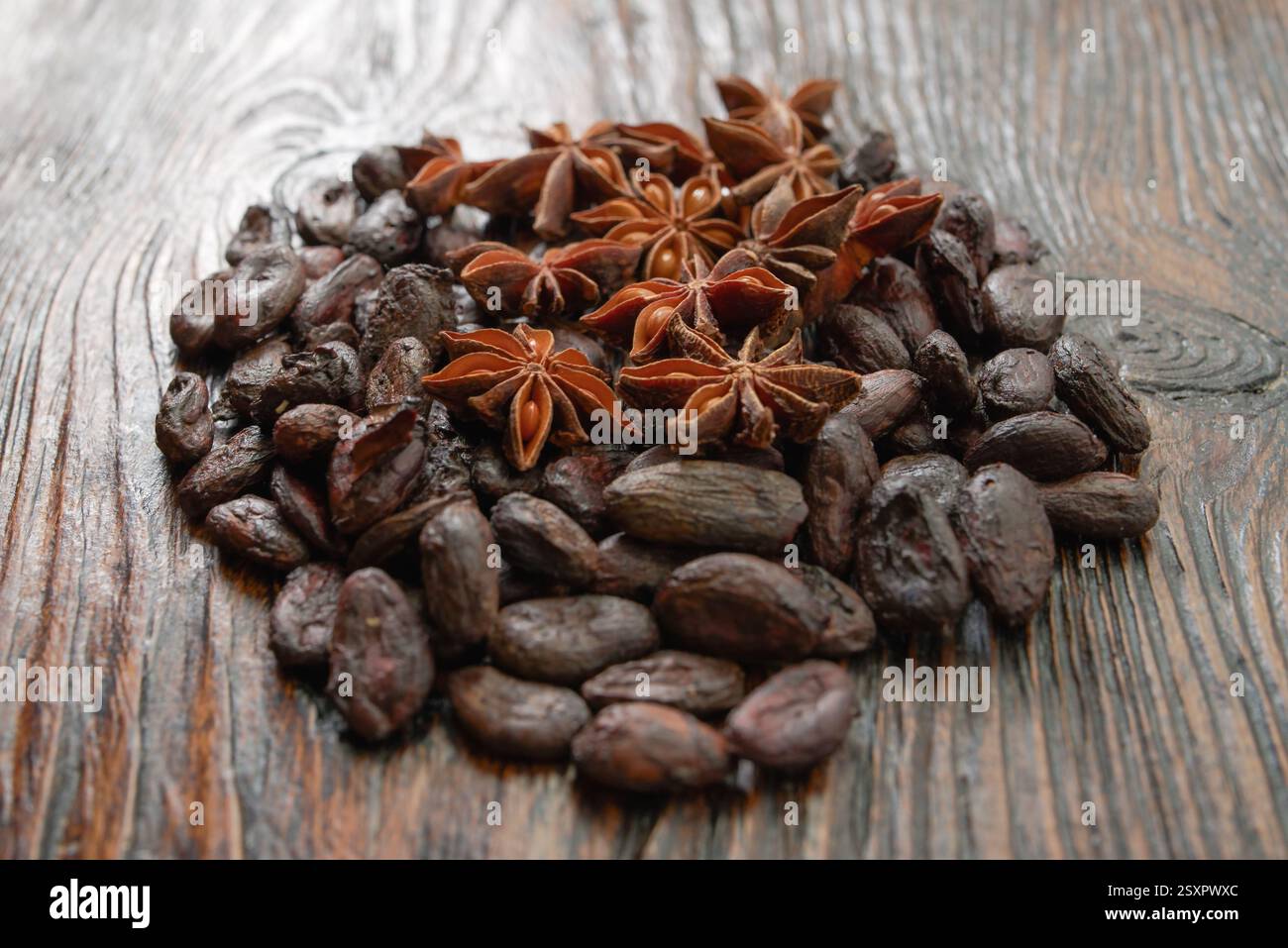 Broken dark chocolate and cocoa beans on the table Stock Photo