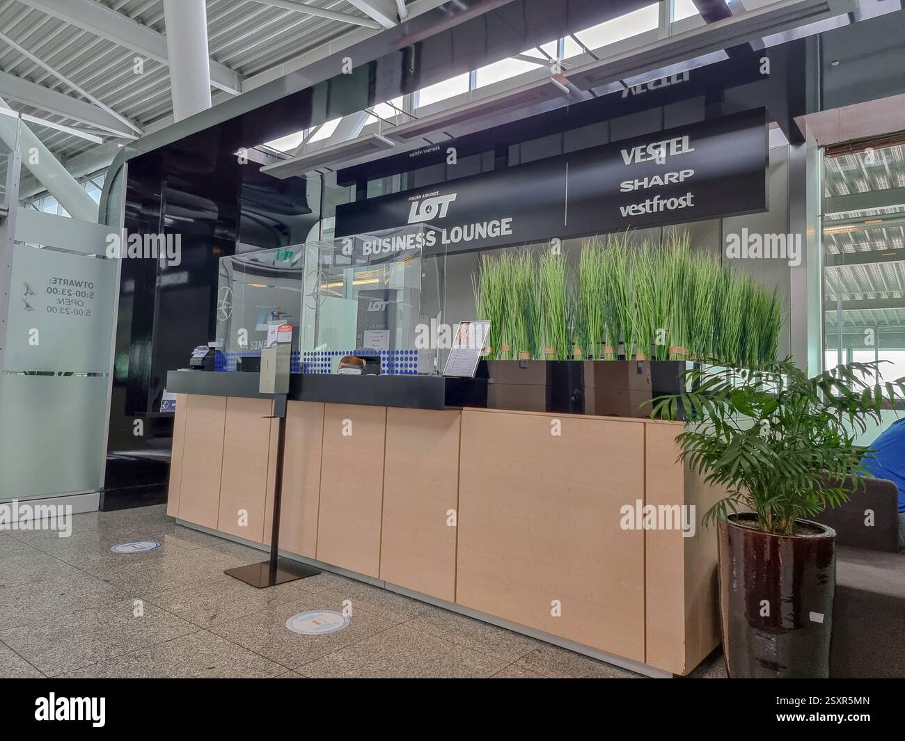 Check-in desk at entrance of LOT business lounge at Warsaw Chopin Airport; executive lounge - Smartphone Captured Stock Image
