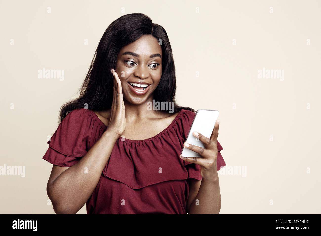 Emotional black woman using nice mobile app on smartphone Stock Photo