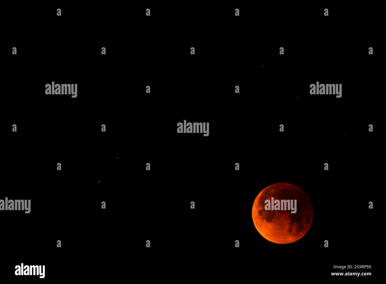 A glowing blood moon during a partial lunar eclipse at night. Stock Photo