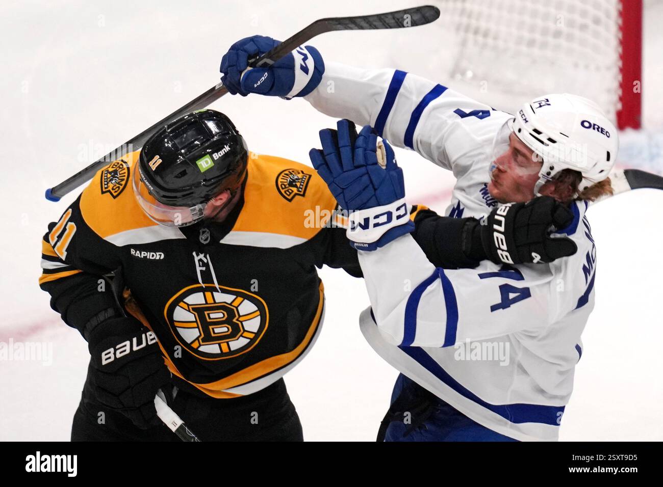 Boston Bruins center Trent Frederic (11) shoves Toronto Maple Leafs center Bobby McMann (74