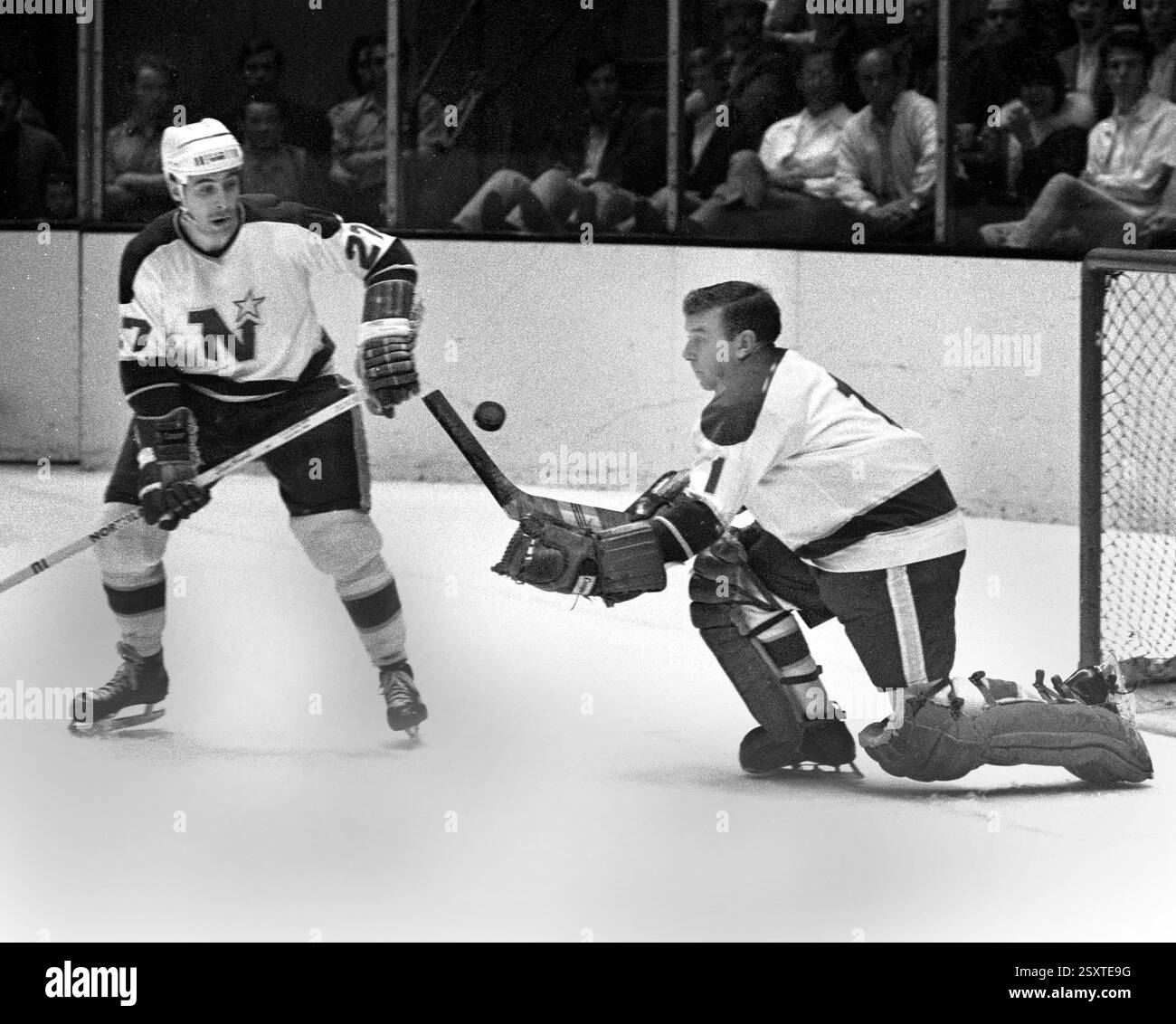 Minnesota North Stars Wayne Muloin (27) and goalie Gump Worsley (1 ...