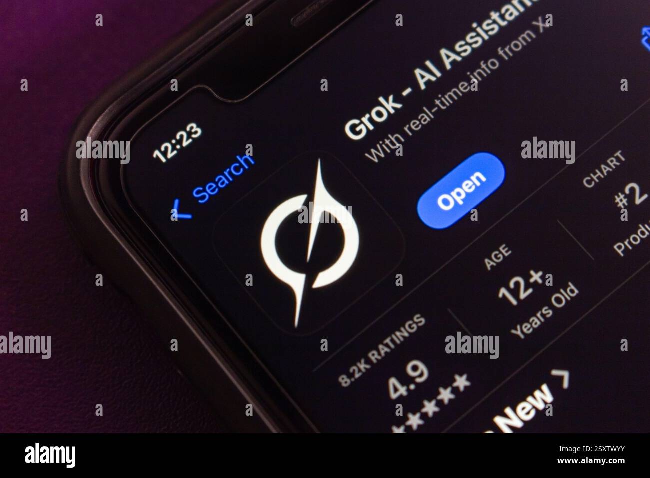 Grok app with a new logo displayed on App Store. Grok is an AI chatbot developed by Elon Musk's xAI, integrated with X to provide real-time info. Stock Photo