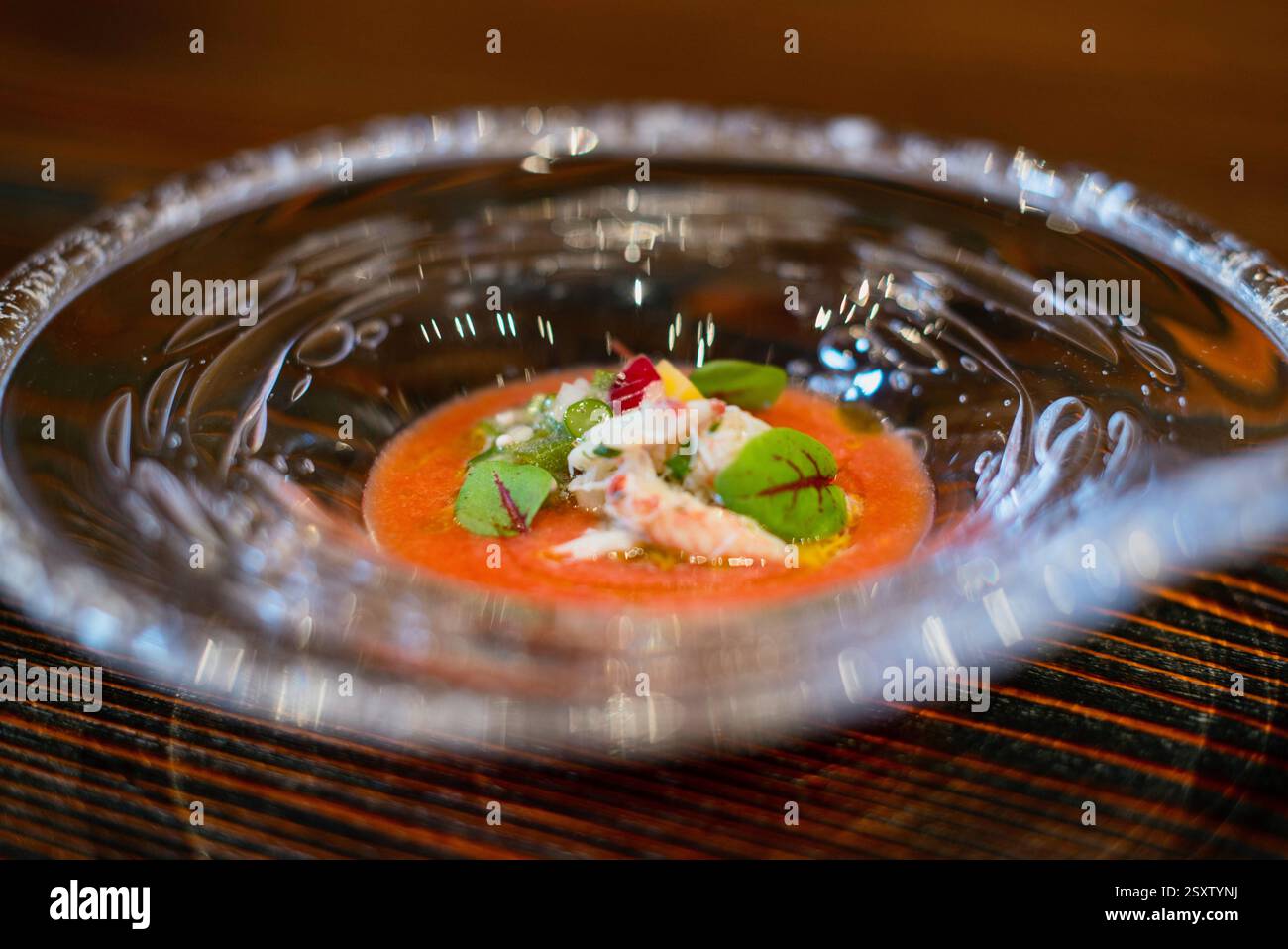 A tomato soup with pureed aubergine, seasonal vegetables and shrimp is served at Cave Yunoki French restaurant in Toyoma City, Japan. Stock Photo