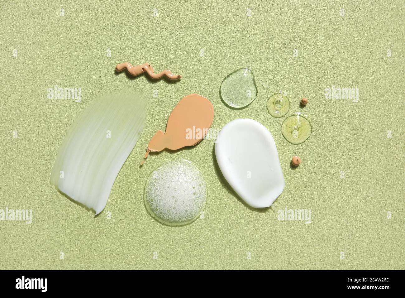 Composition with samples of different cosmetic products on green ...