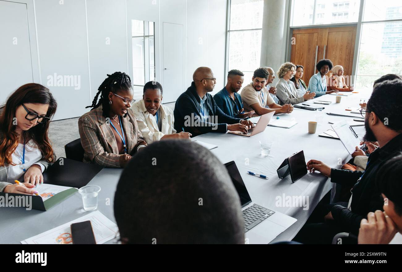 Diverse group of people engaged in a business meeting, discussing ideas ...
