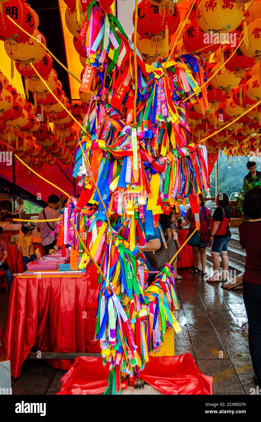Prayer and wishes on coloured ribbons tied to a prayer tree as a prayer ...