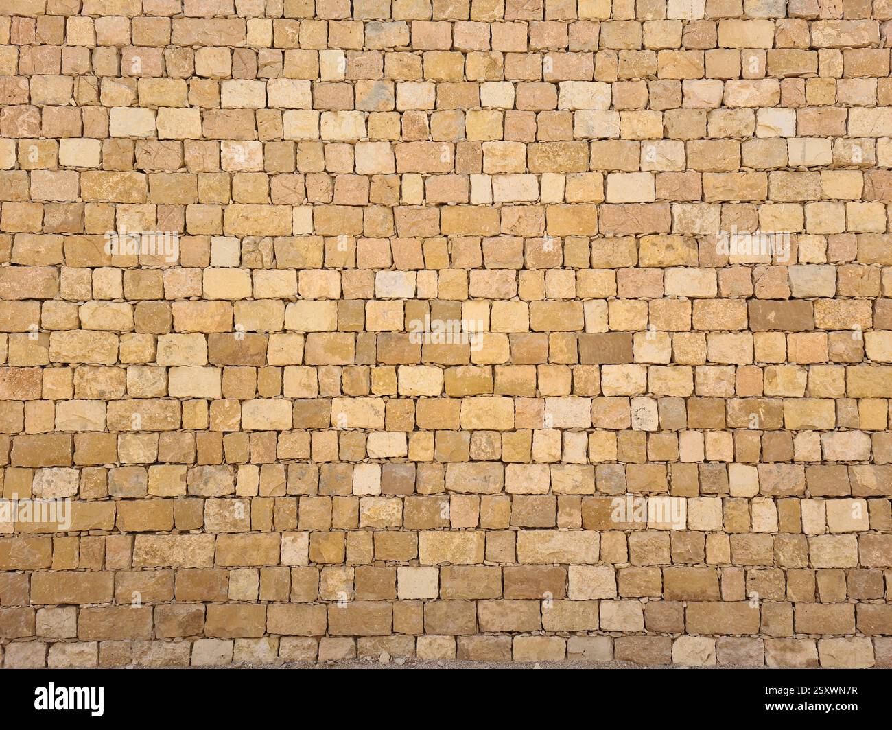 Close-up of a regular yellow limestone brick wall in Riyadh, Saudi Arabia - Smartphone Captured Stock Image
